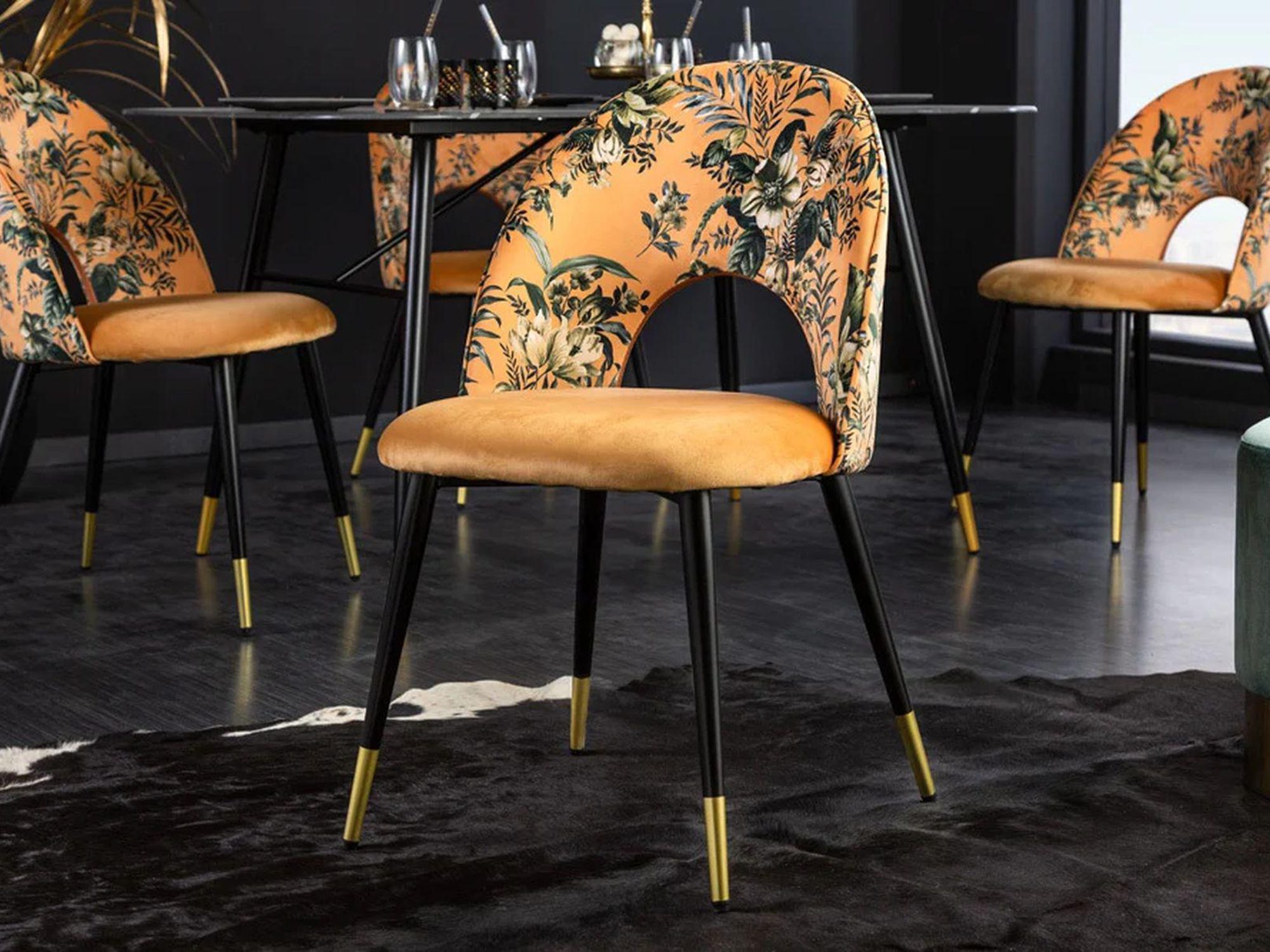 Krzesło z tapicerką w kwiaty i złotymi nogami w eleganckim salonie Krzesło z tapicerką w kwiaty i złotymi nogami w eleganckim salonie