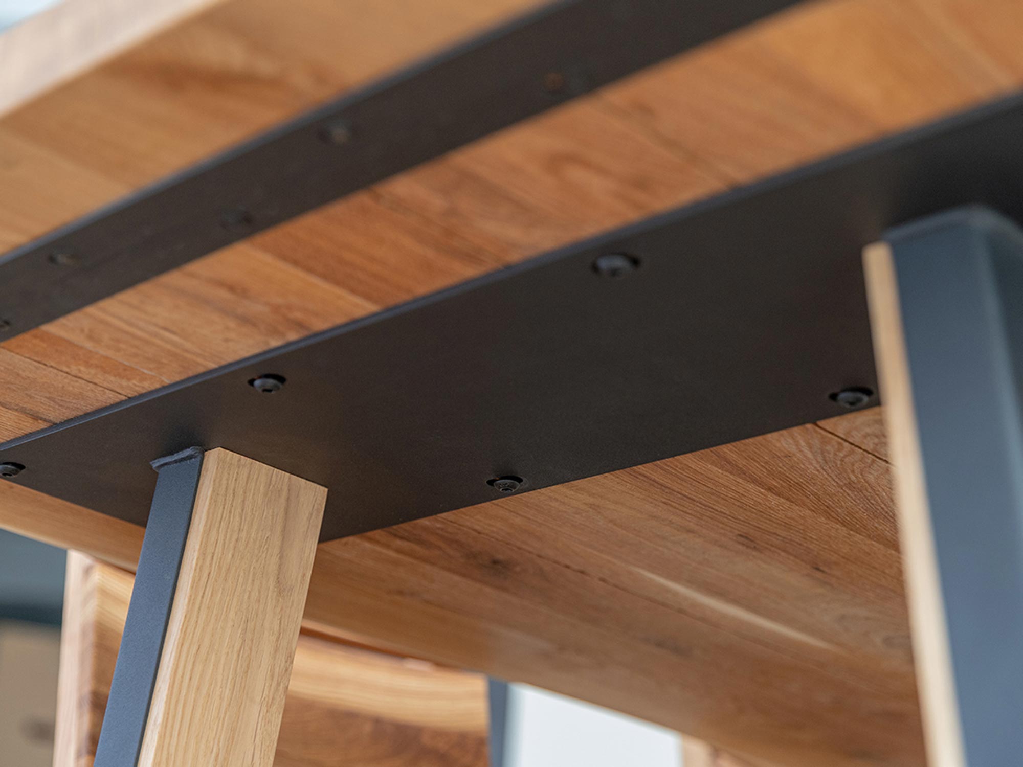 Detal połączenia blatu i metalowej nogi w stole loftowym