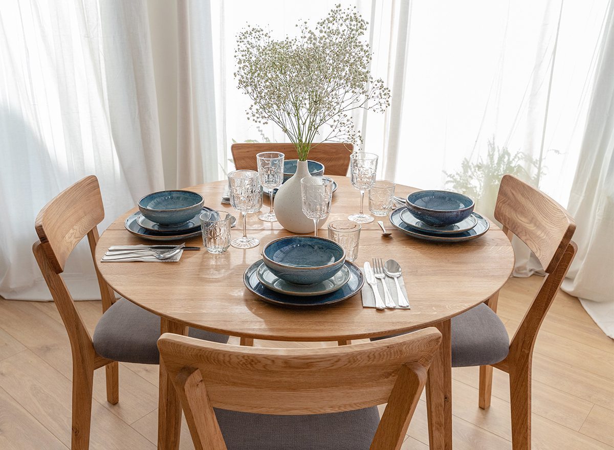 Nowoczesna jadalnia z okrągłym stołem i tapicerowanymi krzesłami