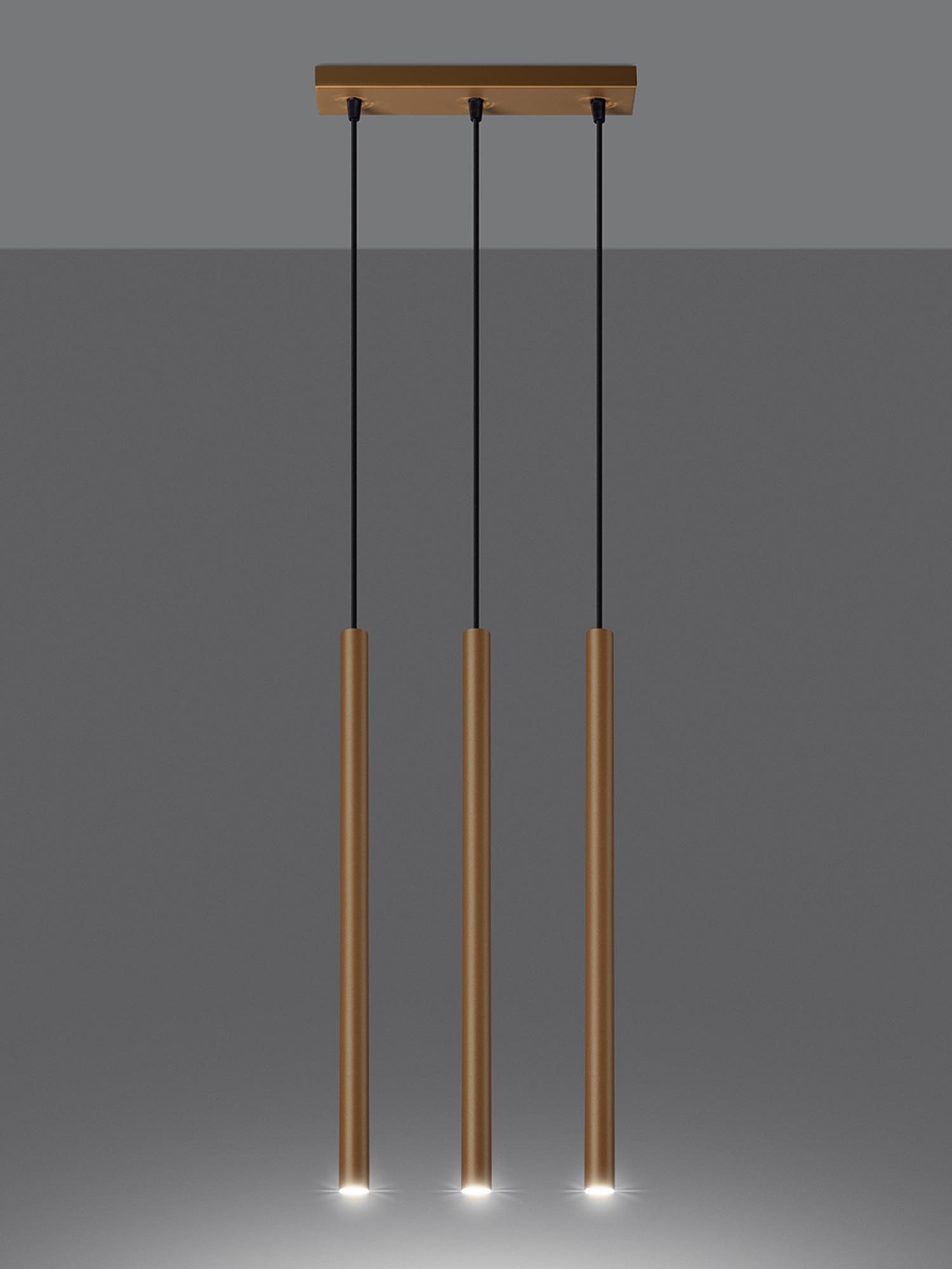 Złote tuby LED zawieszone na czarnych przewodach Złote tuby LED zawieszone na czarnych przewodach