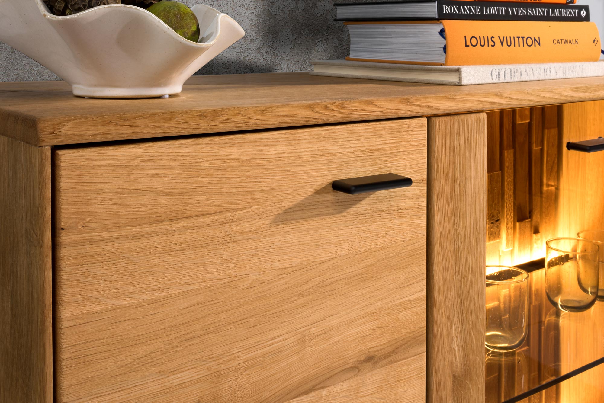 Detal na komodę drewniana z czarnymi uchwytami