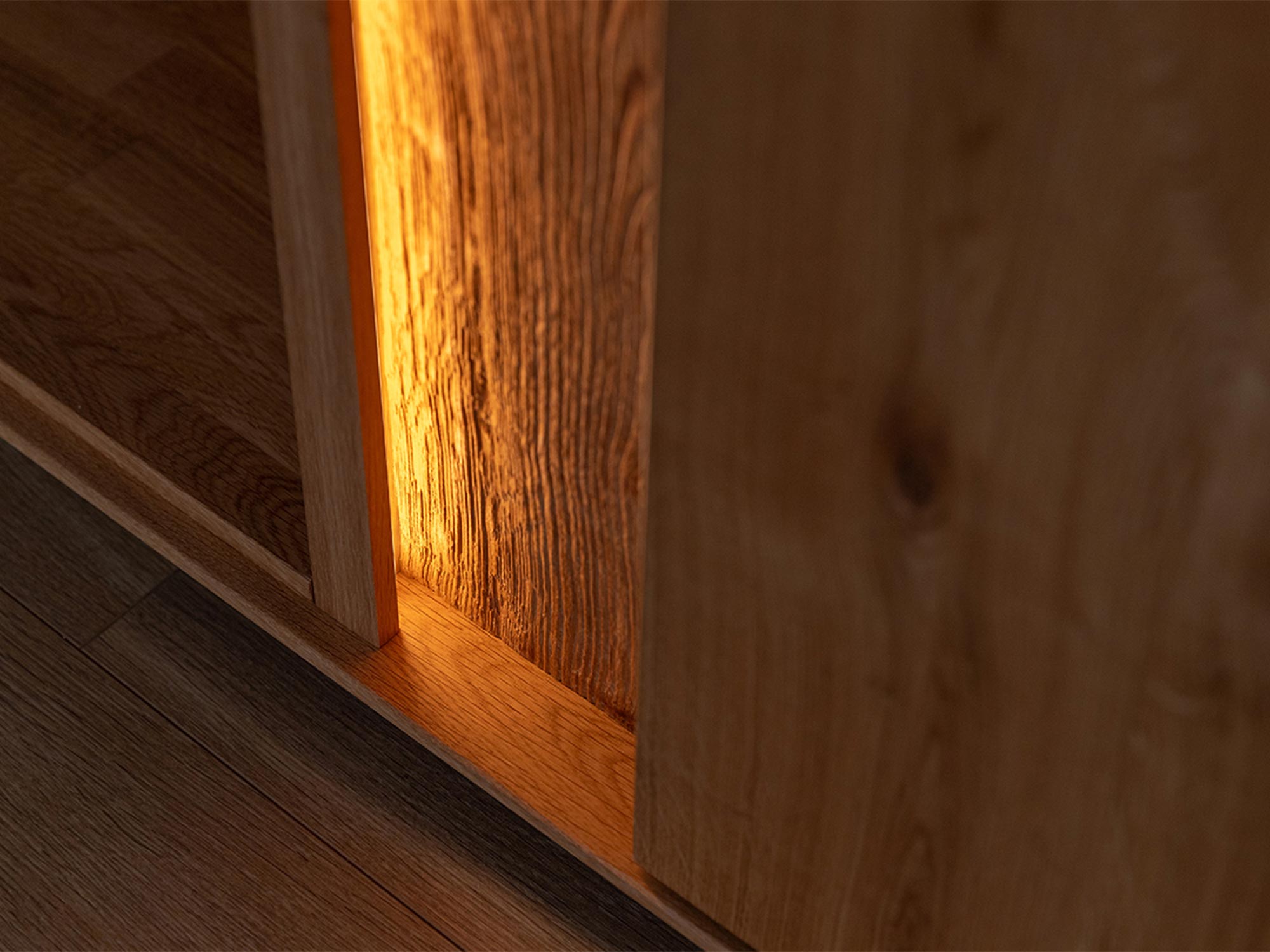 Zbliżenie na detal drewniany szafki RTV z podświetleniem