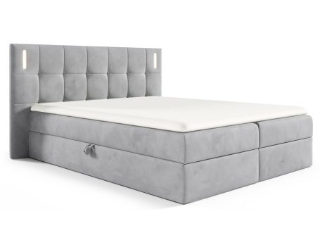 Łóżko tapicerowane w jasno szarym kolorze z pikowanym zagłówkiem