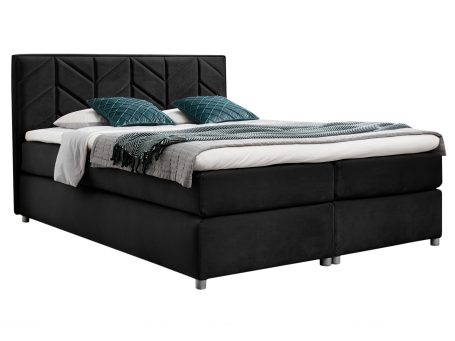Tapicerowane łóżko w kolorze czarnym na białym tle