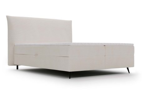 Białe łóżko tapicerowane z pojemnikiem i miękkim zagłówkiem w nowoczesnej sypialni