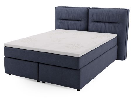 Granatowe łóżko tapicerowane z prostym przeszyciem i wyraźną strukturą tkaniny