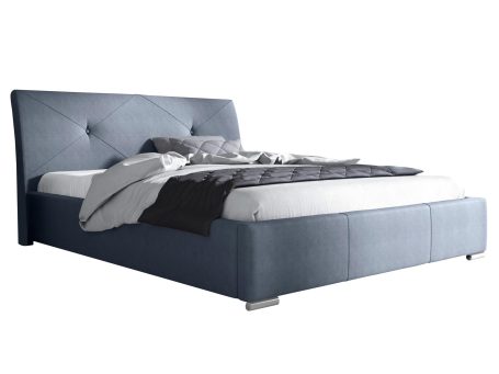 Niebieskie łóżko sypialniane z wysokim pikowanym zagłówkiem i miękką narzutą