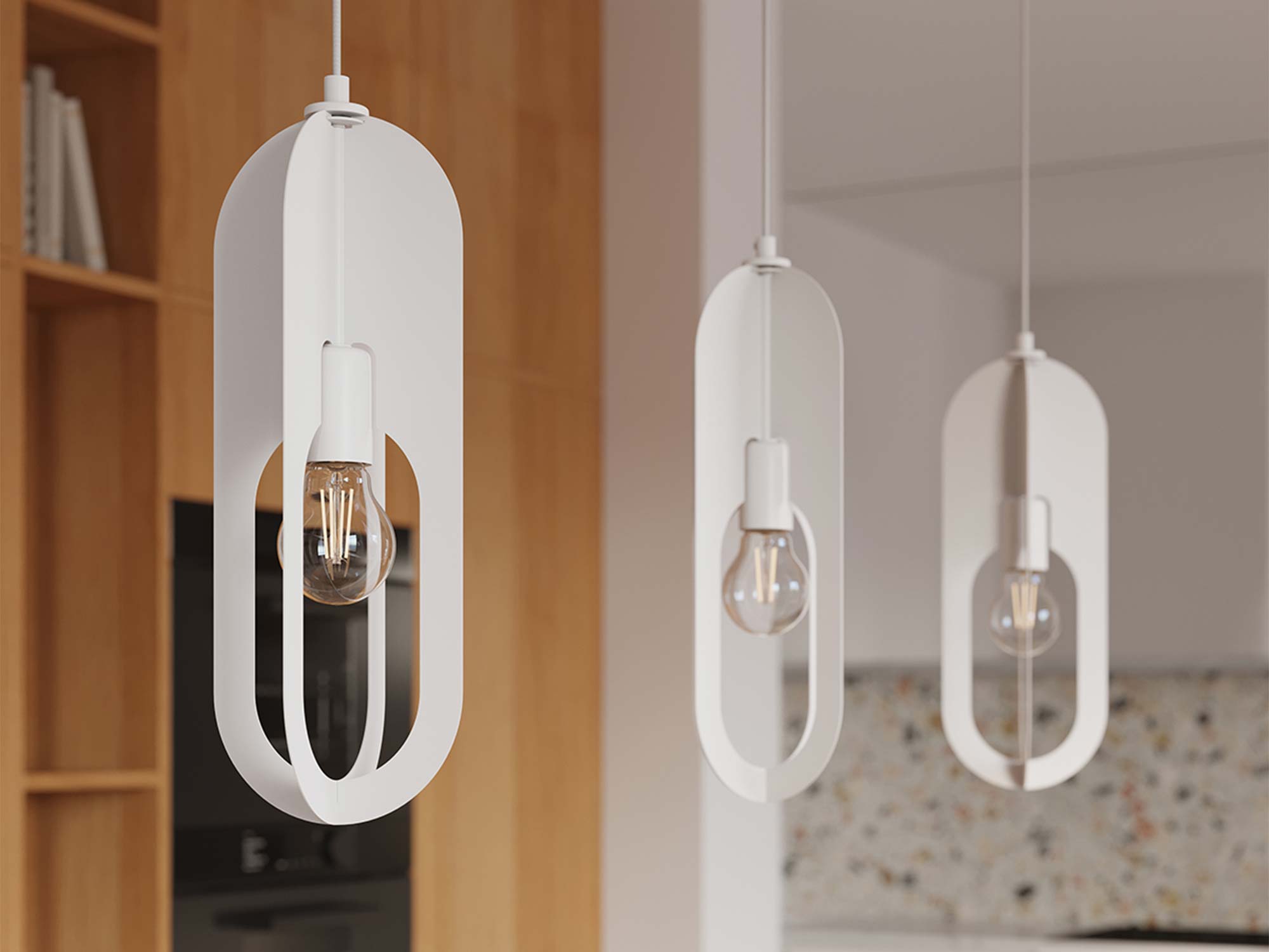 Trzy białe lampy wiszące z owalnymi kloszami ażurowymi w aranżacji kuchni zbliżenie