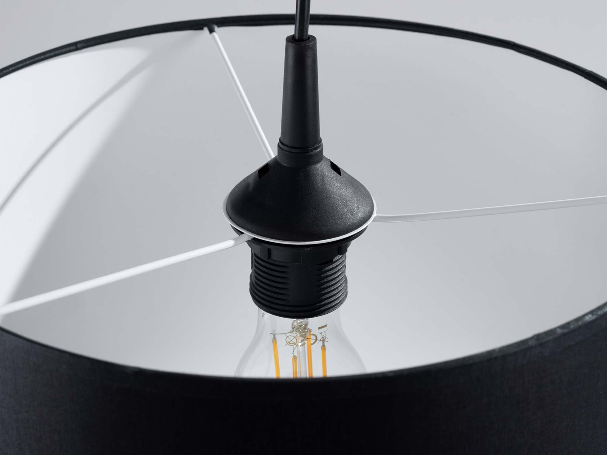 Mocowanie żarówki LED wewnątrz czarnego abażura lampy wiszącej