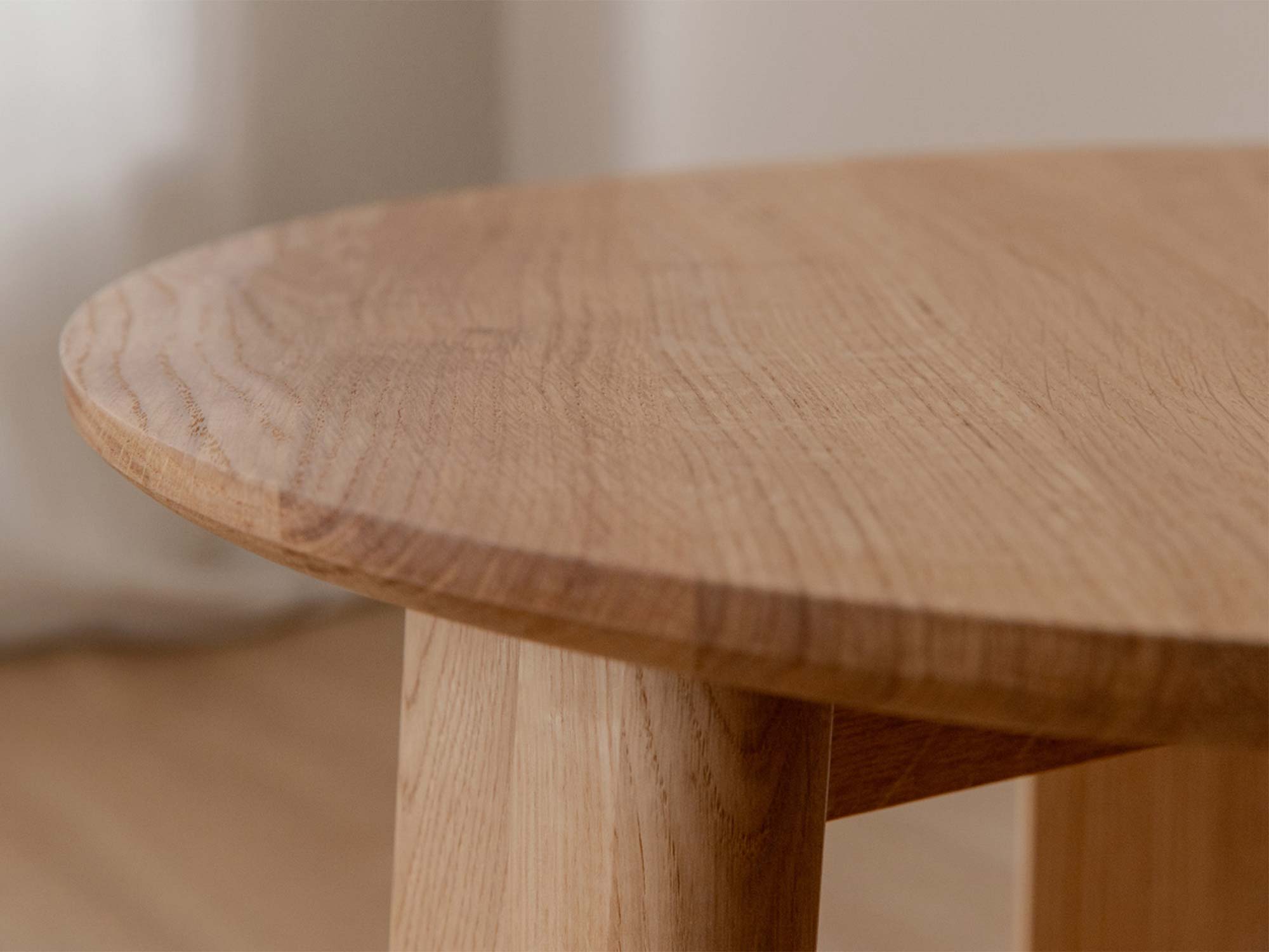 Detal blatu dębowego stolika kawowego z widocznym usłojeniem i nogą